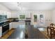 Traditional kitchen with white cabinets, a black countertop island and stainless steel appliances at 10519 N Antioch Rd, Mooresville, IN 46158