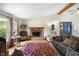 Welcoming living room with a brick fireplace, hardwood floors, and vaulted ceiling at 10519 N Antioch Rd, Mooresville, IN 46158
