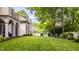 Stunning backyard with lush green lawn, mature trees, and a charming white fence at 110 Bow Ln, Indianapolis, IN 46220