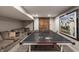 Basement recreation room features a ping pong table and comfortable seating at 110 Bow Ln, Indianapolis, IN 46220