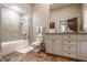 Well-lit bathroom with a tiled shower, vanity with storage, and modern fixtures at 110 Bow Ln, Indianapolis, IN 46220