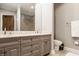 Elegant bathroom featuring a double vanity with granite countertops and modern fixtures at 110 Bow Ln, Indianapolis, IN 46220