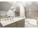 Bright bathroom featuring double vanity, bathtub and tiled shower at 110 Bow Ln, Indianapolis, IN 46220