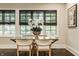 Bright dining area with a glass table, upholstered chairs, and decorative floral arrangement at 110 Bow Ln, Indianapolis, IN 46220