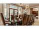 Spacious dining room with a long wood table, leather chairs, and stylish pendant lighting at 110 Bow Ln, Indianapolis, IN 46220