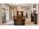 Elegant dining room with a large wooden table, leather chairs, and statement lighting fixture at 110 Bow Ln, Indianapolis, IN 46220