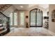 Inviting foyer featuring a decorative iron door, tile flooring, and elegant accents offering a warm welcome at 110 Bow Ln, Indianapolis, IN 46220