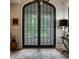 Grand foyer showcasing an ornate iron door, tile flooring, and elegant decor creating a lasting impression at 110 Bow Ln, Indianapolis, IN 46220