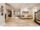 Spacious foyer with travertine floors, elegant stairway, and direct access to the outdoor patio and backyard at 110 Bow Ln, Indianapolis, IN 46220