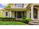 Welcoming front entrance featuring stone steps, manicured hedges, and vibrant flower beds creating curb appeal at 110 Bow Ln, Indianapolis, IN 46220