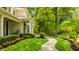 Picturesque home showcasing a stone walkway, vibrant flower beds, and meticulously maintained greenery at 110 Bow Ln, Indianapolis, IN 46220