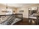 Hallway landing with ornate iron railing, hardwood floors, and decorative chandelier at 110 Bow Ln, Indianapolis, IN 46220