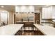Gourmet kitchen with stainless steel refrigerator and appliances, marble counters, and wooden cabinets at 110 Bow Ln, Indianapolis, IN 46220
