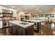 Open kitchen with marble island countertops, hardwood floors, stainless steel appliances, and view of the living room at 110 Bow Ln, Indianapolis, IN 46220