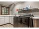 Laundry room featuring modern appliances, white cabinetry, and ample counter space at 110 Bow Ln, Indianapolis, IN 46220