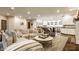 Bright, open living room and kitchen featuring a large, comfortable sectional sofa and modern appliances at 110 Bow Ln, Indianapolis, IN 46220