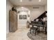 Well appointed living room with a baby grand piano, zebra rug, and arched entryway at 110 Bow Ln, Indianapolis, IN 46220