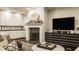 Comfortable living room with fireplace, a view of the gourmet kitchen, and hardwood floors at 110 Bow Ln, Indianapolis, IN 46220