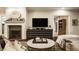 Inviting living room featuring a stone fireplace, large-screen television, and ample seating at 110 Bow Ln, Indianapolis, IN 46220