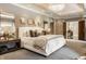 Spacious main bedroom with plush carpet, neutral colors, and tray ceiling with modern lighting at 110 Bow Ln, Indianapolis, IN 46220