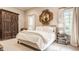 Serene main bedroom featuring a luxurious bed, wooden wardrobe, and abundant natural light at 110 Bow Ln, Indianapolis, IN 46220