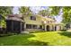 Beautiful rear exterior of the home showcasing a spacious backyard, balcony, and tiled roof at 110 Bow Ln, Indianapolis, IN 46220