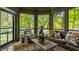 Cozy sunroom with comfortable seating and views of the lush backyard at 110 Bow Ln, Indianapolis, IN 46220