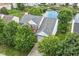 A beautiful brick two-story home surrounded by lush green trees and landscaping, with a view of a nearby pond at 11820 Stepping Stone Dr, Fishers, IN 46037