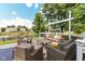 Well-appointed backyard deck offers a serene outdoor living space with comfortable seating and a picturesque pond view at 11820 Stepping Stone Dr, Fishers, IN 46037