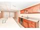 Wet bar in basement includes bar top seating, storage, sink, and beverage fridge at 11820 Stepping Stone Dr, Fishers, IN 46037