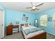 Bright bedroom with cheerful turquoise walls, plush carpet, and natural light from two windows at 11820 Stepping Stone Dr, Fishers, IN 46037