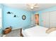 Bright bedroom with cheerful turquoise walls, plush carpet, and natural light from two windows at 11820 Stepping Stone Dr, Fishers, IN 46037