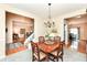Traditional dining room with wooden furniture set, a chandelier, and views into the living and dining spaces at 11820 Stepping Stone Dr, Fishers, IN 46037