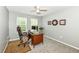 Comfortable home office with a large desk, plush chair, and natural light for a productive workspace at 11820 Stepping Stone Dr, Fishers, IN 46037