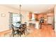 Bright kitchen features hardwood floors, stainless steel appliances, wood cabinets and a dining area at 11820 Stepping Stone Dr, Fishers, IN 46037