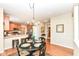 Kitchen and dining area showing wood floors, appliances, and a round dining table at 11820 Stepping Stone Dr, Fishers, IN 46037