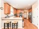 Kitchen features wood cabinets, stainless appliances and a breakfast bar with counter seating at 11820 Stepping Stone Dr, Fishers, IN 46037