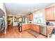 Well-lit kitchen with stainless steel appliances, wood cabinetry, and an open view to the living spaces at 11820 Stepping Stone Dr, Fishers, IN 46037