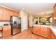 Well-equipped kitchen with stainless steel appliances and wood floors with access to the dining area at 11820 Stepping Stone Dr, Fishers, IN 46037