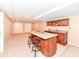 Open-concept living room with bar seating and kitchenette at 11820 Stepping Stone Dr, Fishers, IN 46037