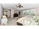 A bright main bedroom with plush carpet, a large bed, and windows with blinds at 11820 Stepping Stone Dr, Fishers, IN 46037