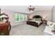 Spacious main bedroom featuring a large bed, vaulted ceilings and ample natural light at 11820 Stepping Stone Dr, Fishers, IN 46037