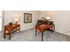A well-appointed home office featuring wood furniture, soft lighting, and neutral-toned carpeting at 11820 Stepping Stone Dr, Fishers, IN 46037