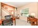 A well-appointed home office featuring wood furniture, soft lighting, and neutral-toned carpeting at 11820 Stepping Stone Dr, Fishers, IN 46037