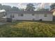 A view of the home's backyard, featuring lawn, white siding and some shade from nearby trees at 1201 E Gimber St, Indianapolis, IN 46203