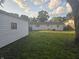 View of the backyard, showcasing the detached garage, white siding, and fenced area at 1201 E Gimber St, Indianapolis, IN 46203