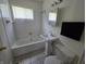 Standard bathroom featuring a tub and shower combination, white sink, and tiled floor at 1201 E Gimber St, Indianapolis, IN 46203