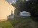 A view of the home's backyard, featuring a lawn, a white garage and the fenced area at 1201 E Gimber St, Indianapolis, IN 46203