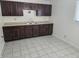 Efficient kitchen features dark wood cabinets and ample counter space for meal preparation at 1201 E Gimber St, Indianapolis, IN 46203