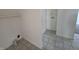 A utility area with white walls and tile floor, ready for laundry equipment and extra storage at 1201 E Gimber St, Indianapolis, IN 46203